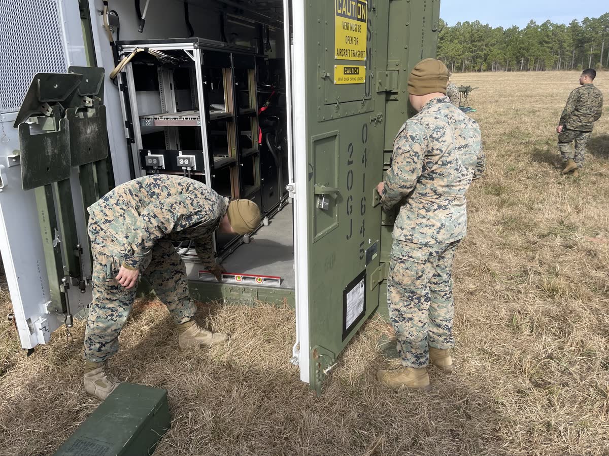 Marines working on field equipment